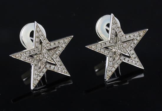 A modern pair of Theo Fennell 18ct white gold and diamond chip encrusted pierced double star design earrings,